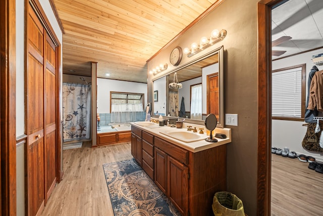 bathroom featuring vanity, a washtub, hardwood / wood-style floors, and wooden ceiling