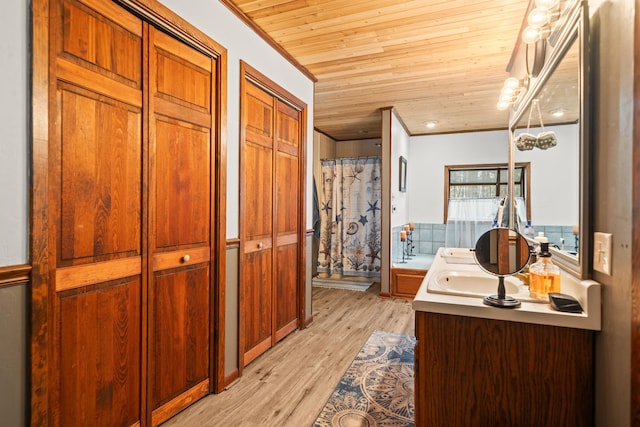 bathroom featuring walk in shower, wood ceiling, crown molding, vanity, and hardwood / wood-style flooring