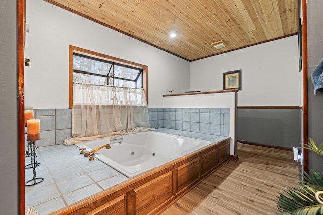 bathroom featuring hardwood / wood-style floors, ornamental molding, wooden ceiling, and a tub