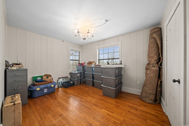 misc room featuring hardwood / wood-style flooring and a chandelier