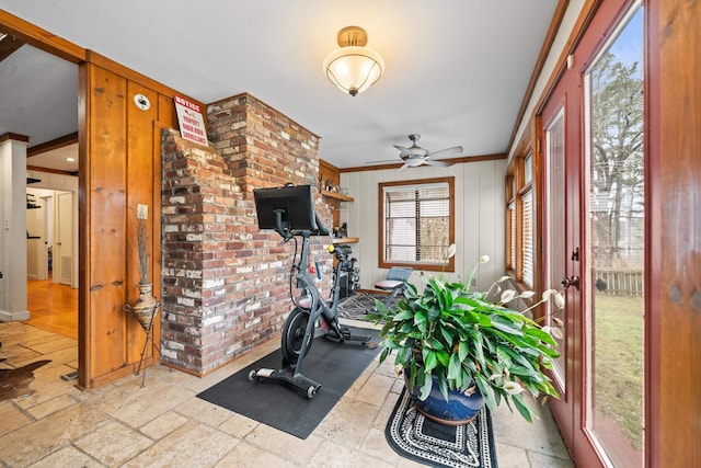 exercise room with ornamental molding and ceiling fan