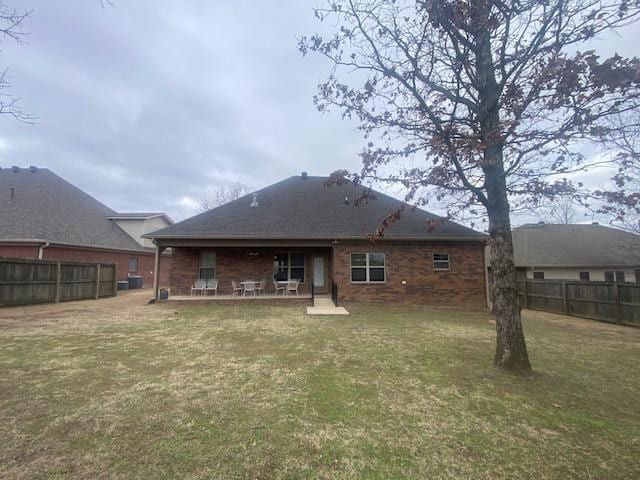 rear view of house with a yard