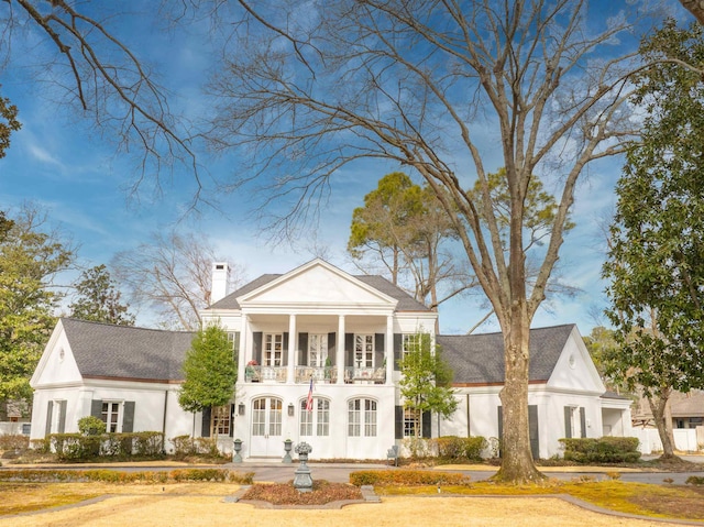 neoclassical home with a balcony