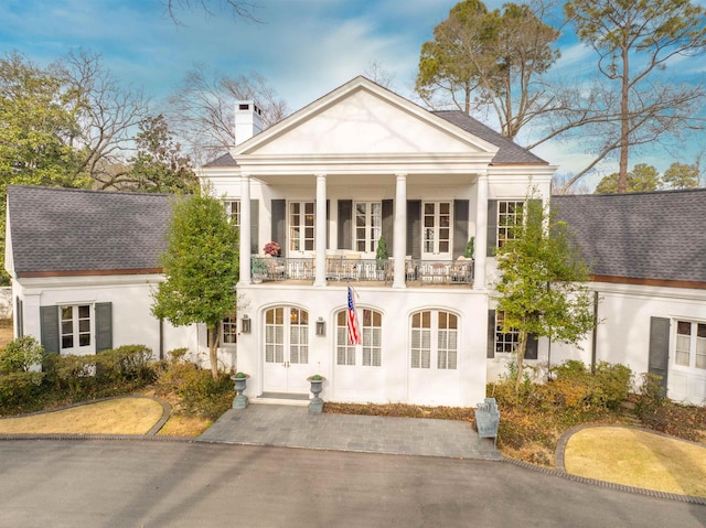 neoclassical / greek revival house featuring a balcony