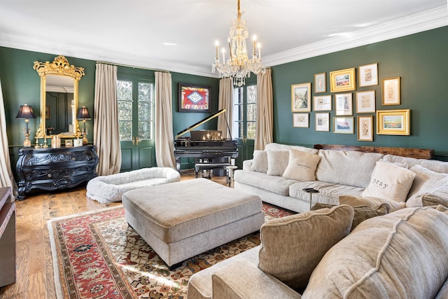 living room with crown molding, a healthy amount of sunlight, an inviting chandelier, and hardwood / wood-style flooring