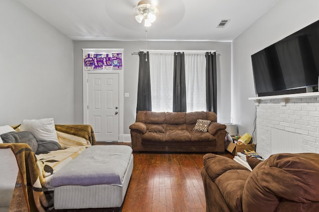 living room featuring dark hardwood / wood-style flooring and ceiling fan