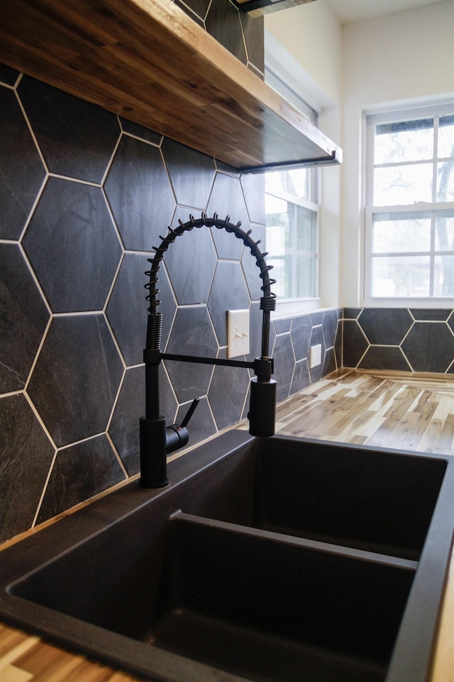 interior details featuring sink and decorative backsplash