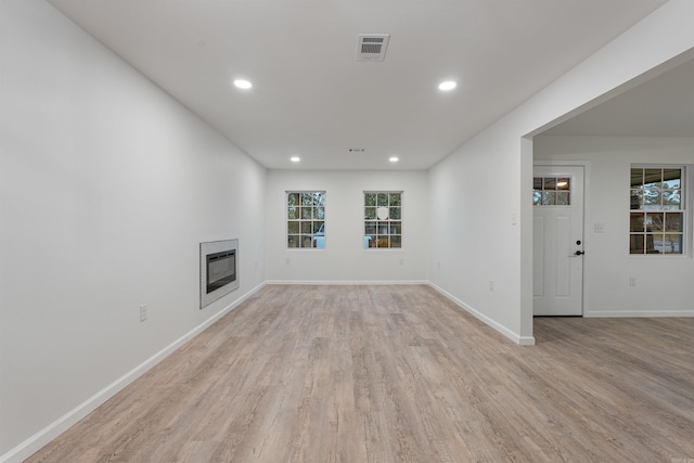 unfurnished living room featuring light hardwood / wood-style floors