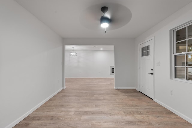 corridor with light hardwood / wood-style flooring