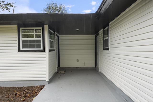 view of exterior entry with a patio