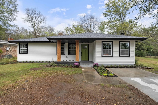 ranch-style home with covered porch and a front lawn