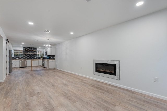 unfurnished living room with light hardwood / wood-style flooring