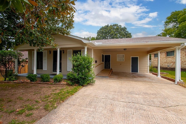 view of front of property featuring a carport and covered porch