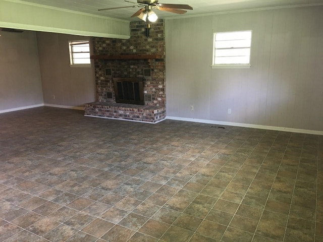 unfurnished living room featuring a fireplace, ornamental molding, and ceiling fan