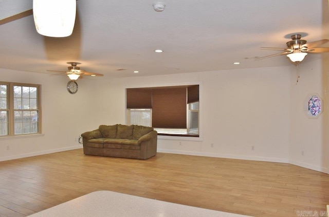 living room featuring ceiling fan and light wood-type flooring