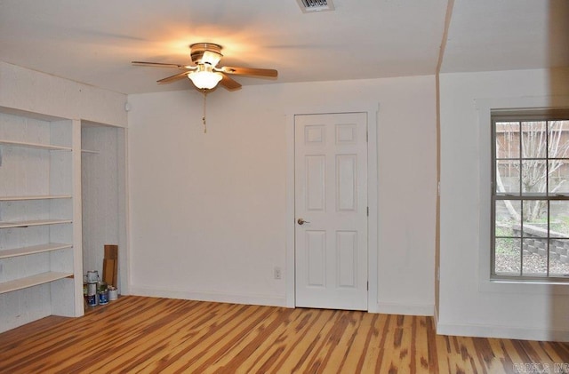 unfurnished bedroom with hardwood / wood-style floors and ceiling fan