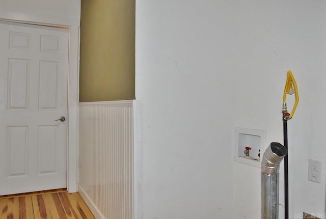 interior space with hookup for a washing machine and wood-type flooring