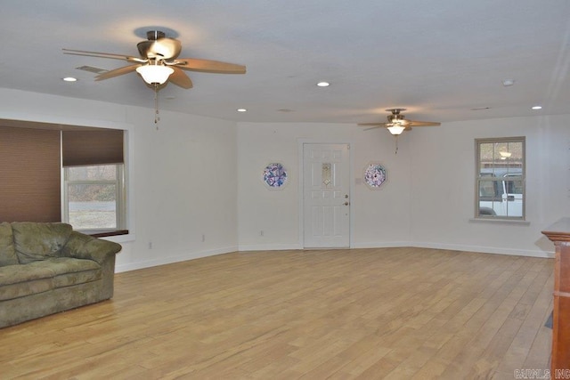 living room featuring light hardwood / wood-style flooring and ceiling fan