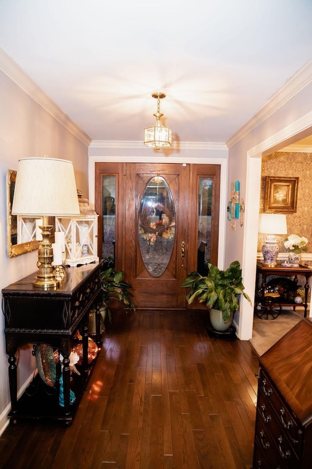 foyer featuring ornamental molding, a notable chandelier, and dark hardwood / wood-style flooring