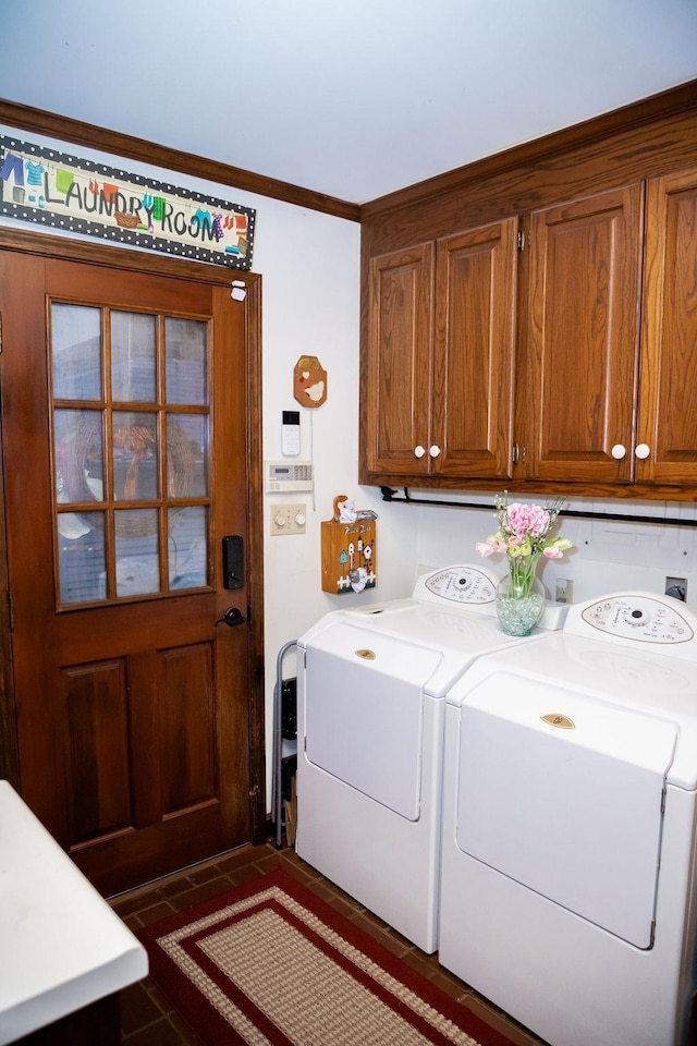 laundry area featuring separate washer and dryer, ornamental molding, and cabinets