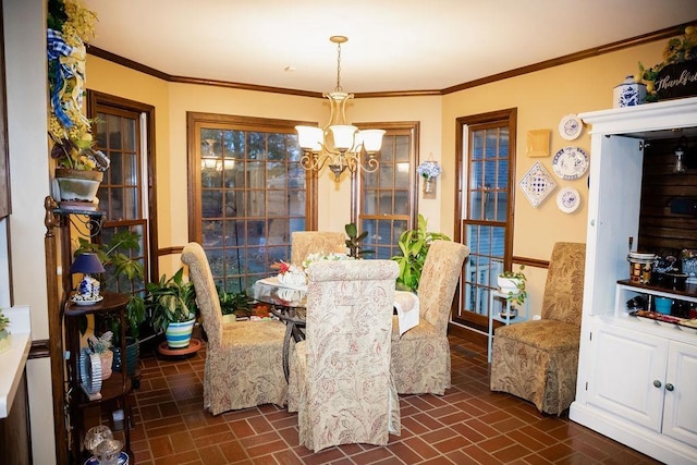 dining area featuring crown molding and a chandelier