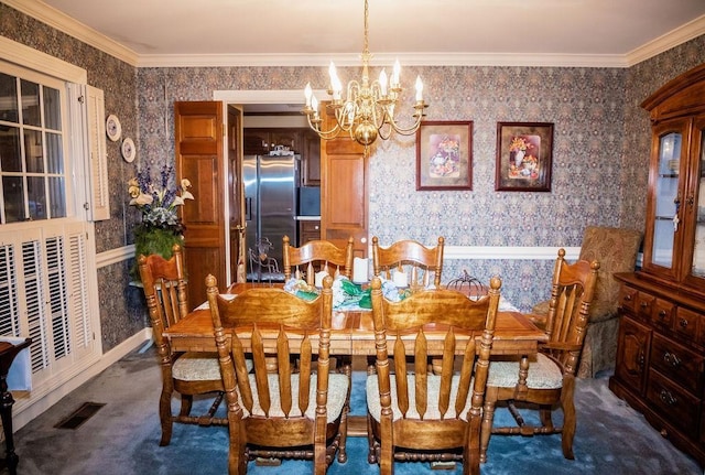 carpeted dining room featuring ornamental molding and a chandelier