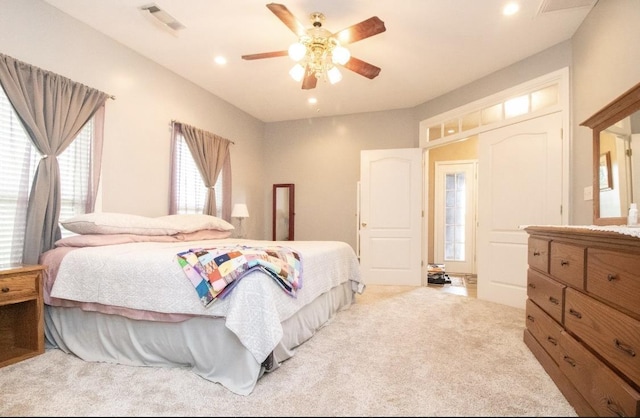 bedroom with ceiling fan and light colored carpet