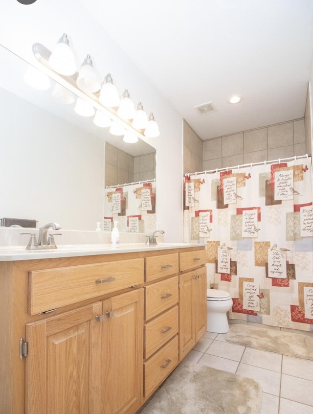 bathroom featuring a shower with curtain, vanity, tile patterned floors, and toilet