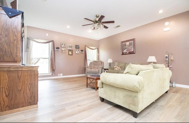 living room featuring ceiling fan and light wood-type flooring