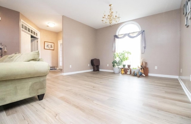 living area with an inviting chandelier and light wood-type flooring