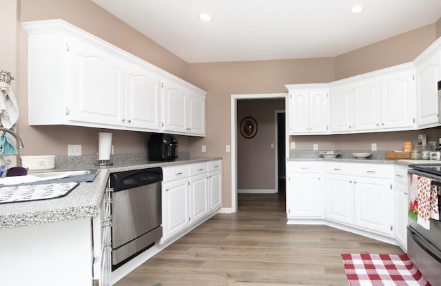 kitchen with sink, light hardwood / wood-style floors, white cabinets, and appliances with stainless steel finishes