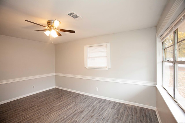 spare room with dark hardwood / wood-style floors and ceiling fan