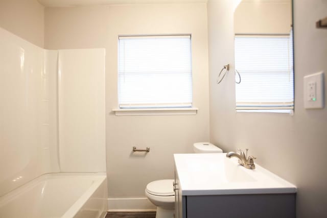 full bathroom featuring hardwood / wood-style flooring, vanity, shower / washtub combination, and toilet