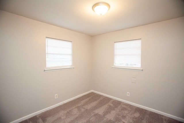 carpeted empty room featuring a healthy amount of sunlight