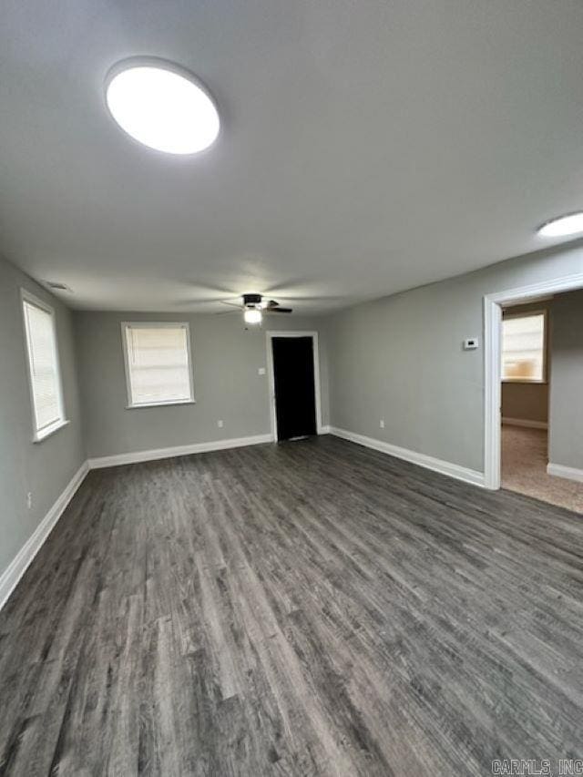 interior space featuring ceiling fan and dark hardwood / wood-style floors