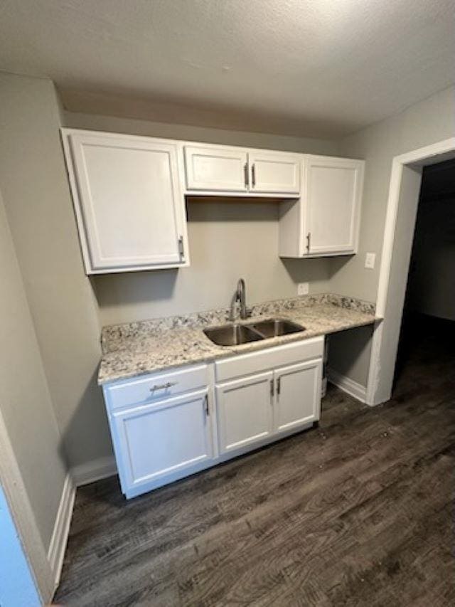 kitchen with sink, dark wood-type flooring, and white cabinets