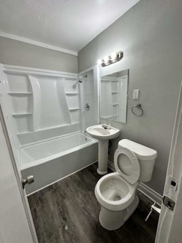 full bathroom featuring hardwood / wood-style floors,  shower combination, sink, and toilet