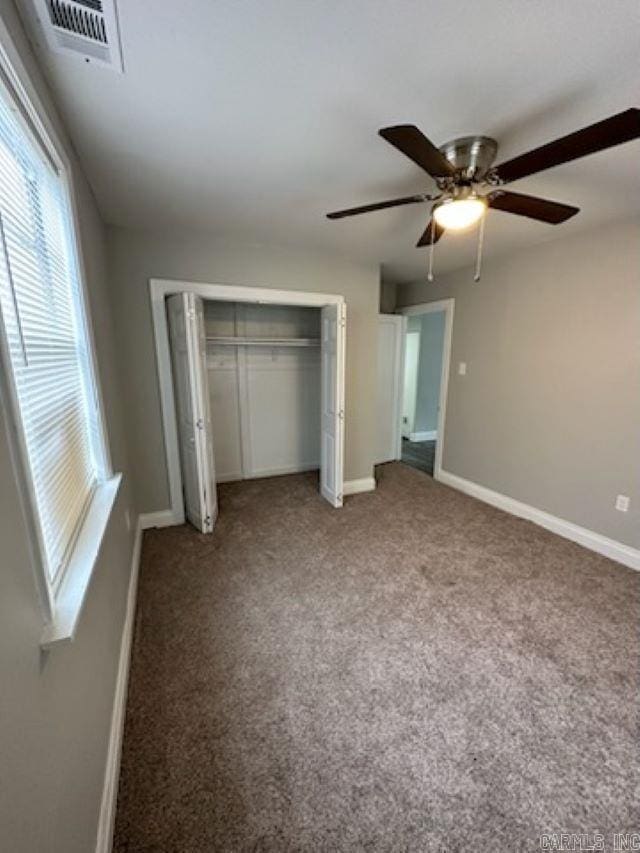 unfurnished bedroom featuring ceiling fan, carpet flooring, and a closet