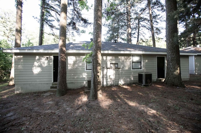 back of house with central air condition unit