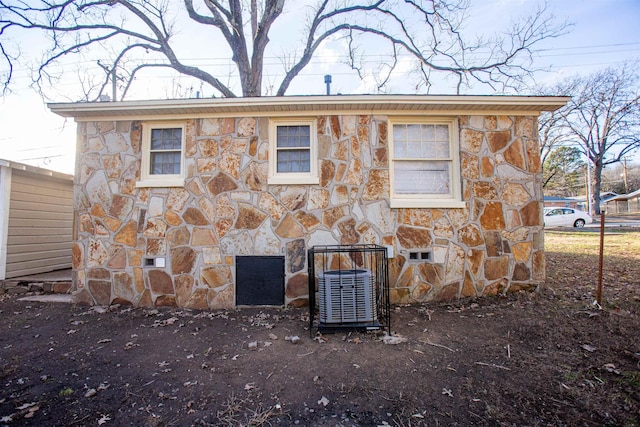 rear view of house featuring central AC unit