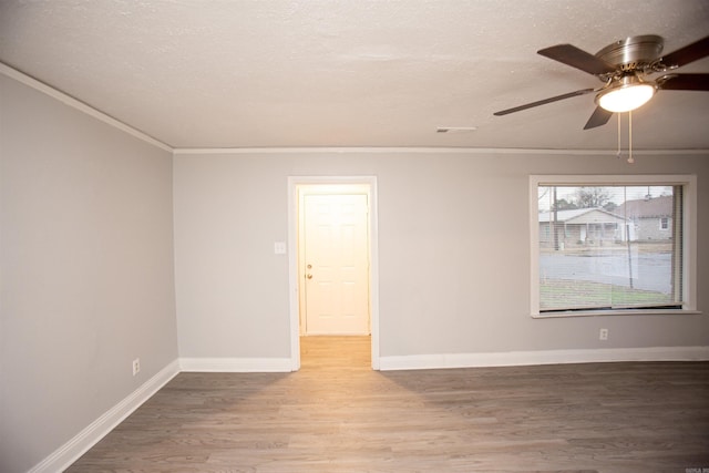 unfurnished room with ceiling fan, hardwood / wood-style flooring, ornamental molding, and a textured ceiling