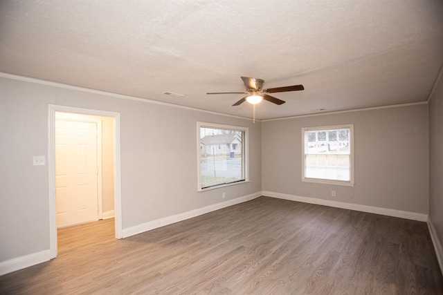 spare room featuring crown molding, ceiling fan, and wood-type flooring