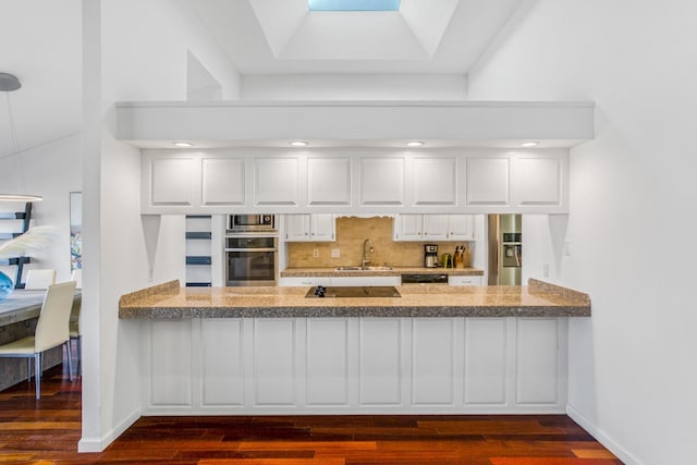 kitchen featuring white cabinetry, backsplash, sink, and black appliances