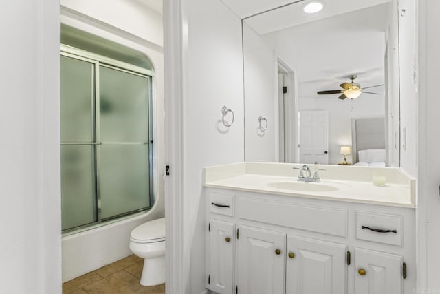 full bathroom with ceiling fan, combined bath / shower with glass door, vanity, tile patterned floors, and toilet