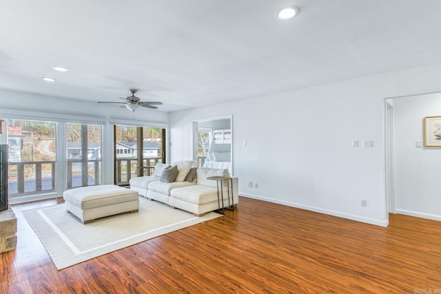 unfurnished living room with ceiling fan and wood-type flooring