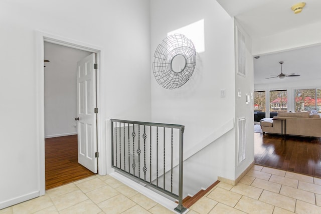 hall with light tile patterned floors