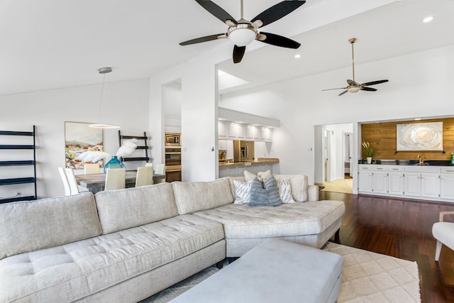 living room with dark wood-type flooring and high vaulted ceiling