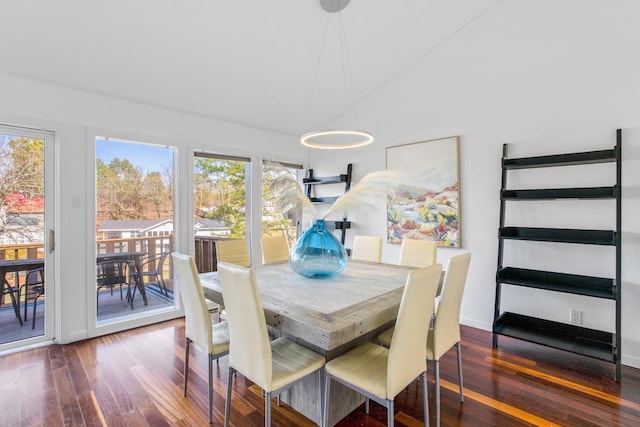 dining area with dark hardwood / wood-style floors and vaulted ceiling