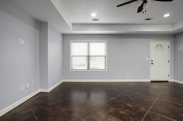 tiled empty room with a textured ceiling and ceiling fan