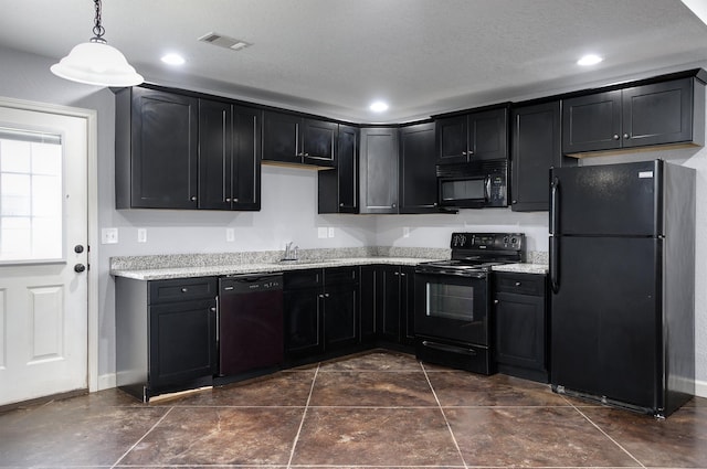 kitchen featuring pendant lighting, sink, light stone counters, black appliances, and a textured ceiling